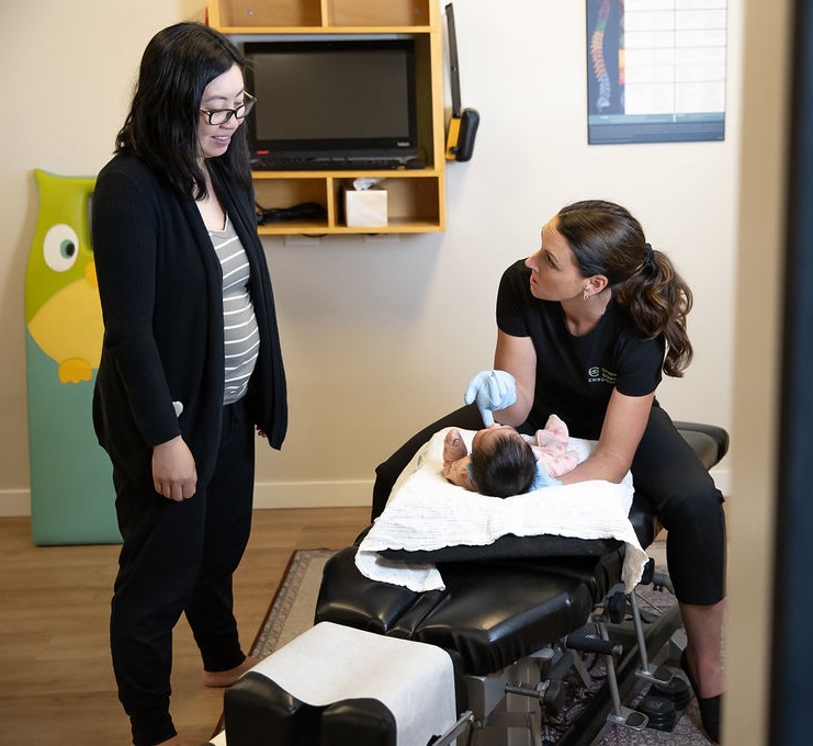 Chiropractor With Baby And Mother