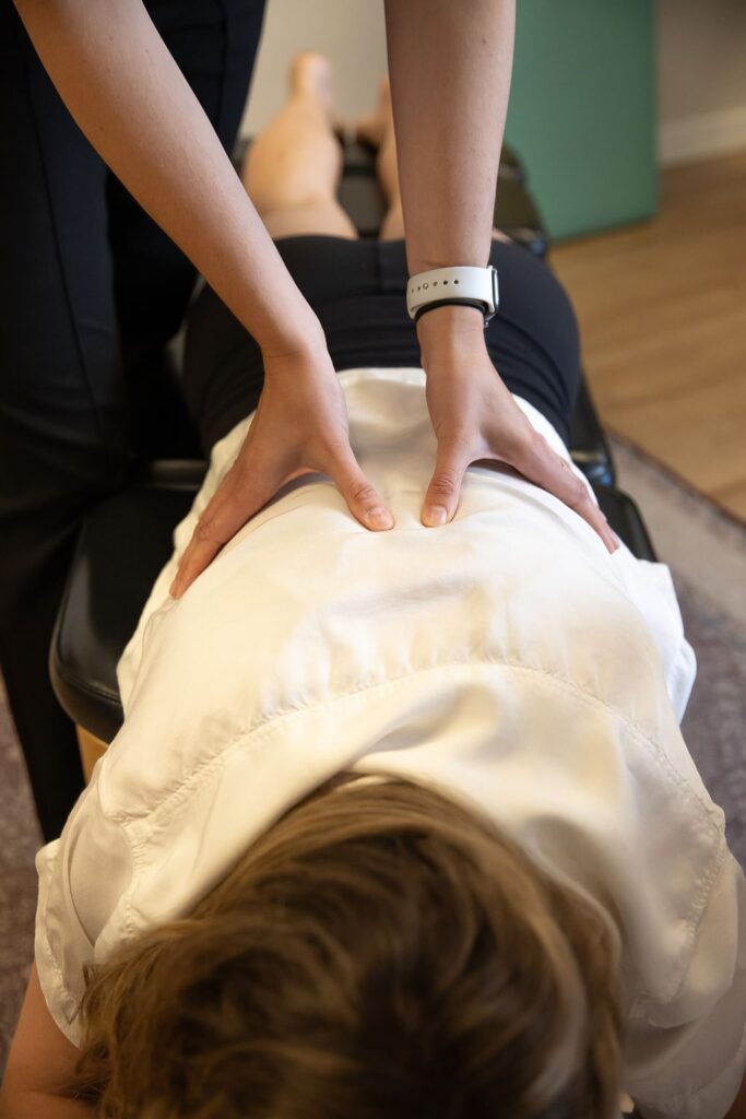 Chiropractor Adjusting Patient's Back